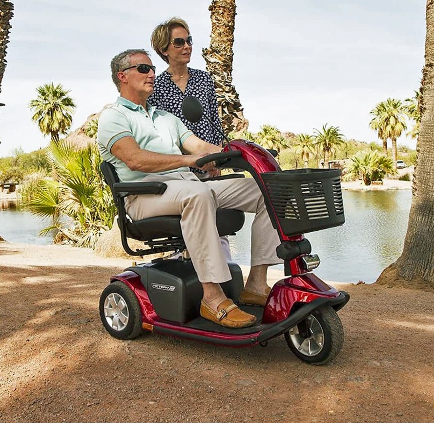 Man Driving a 3-Wheel Full-Size Scooter and the Couple Enjoying the View