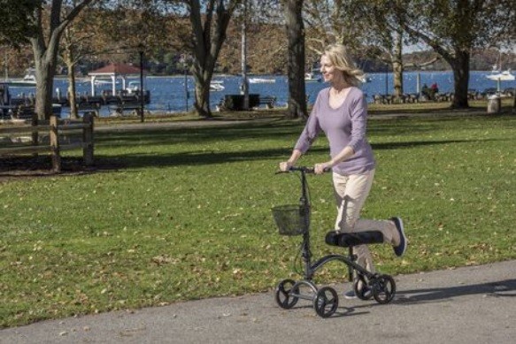 Woman Enjoying the Outdoors Riding on a Knee Walker