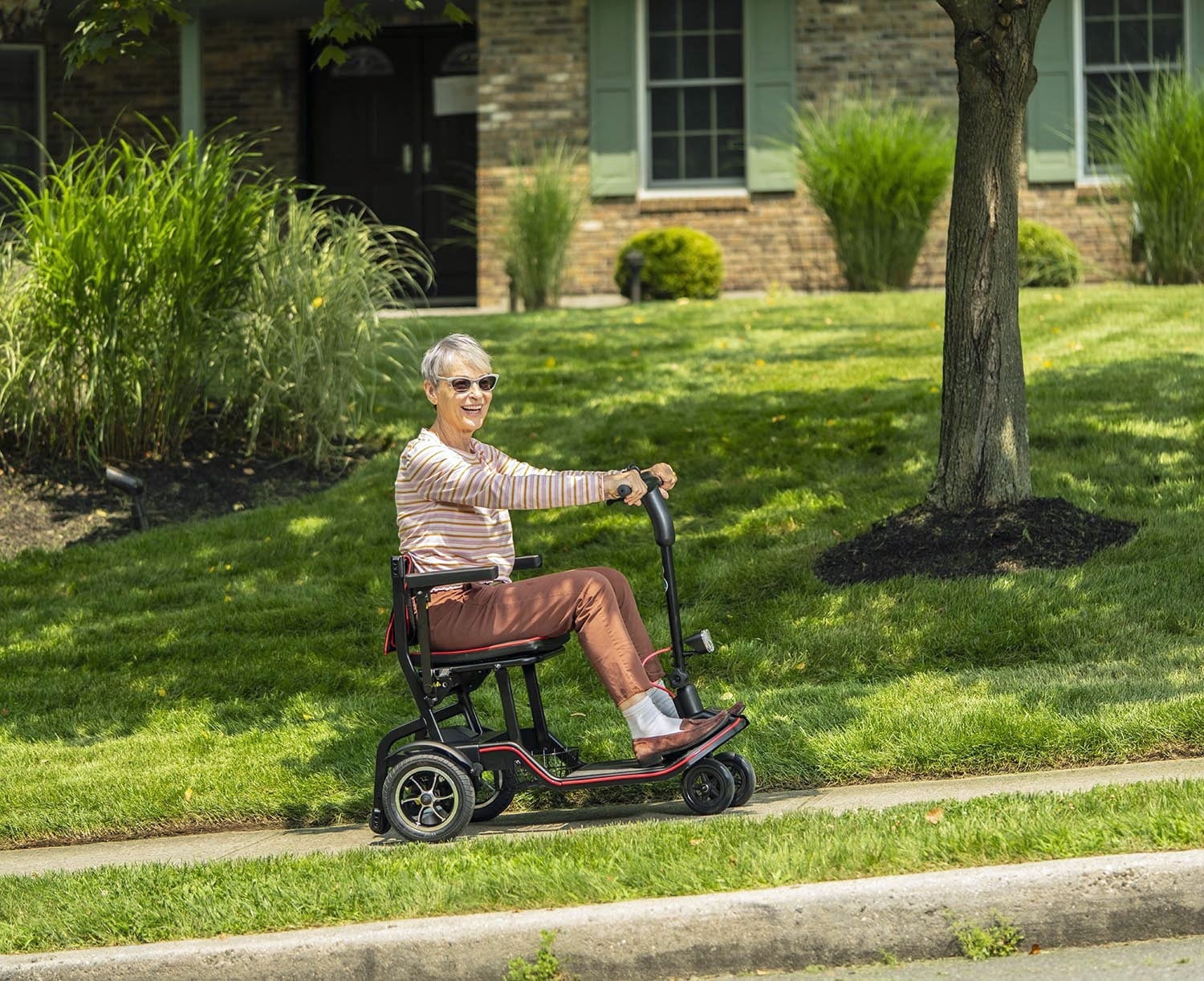 Woman Riding a 4 Wheel Folding Mobility Scooter