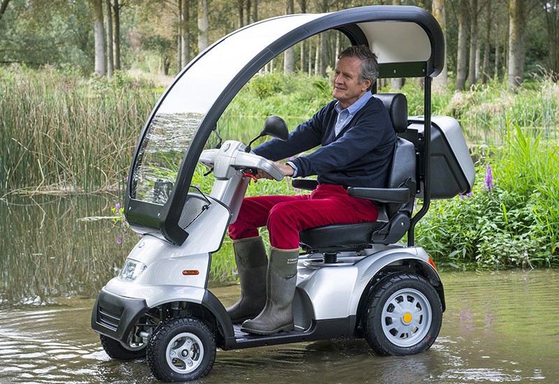 Man Driving a 4-Wheel Canopy Recreational Scooter