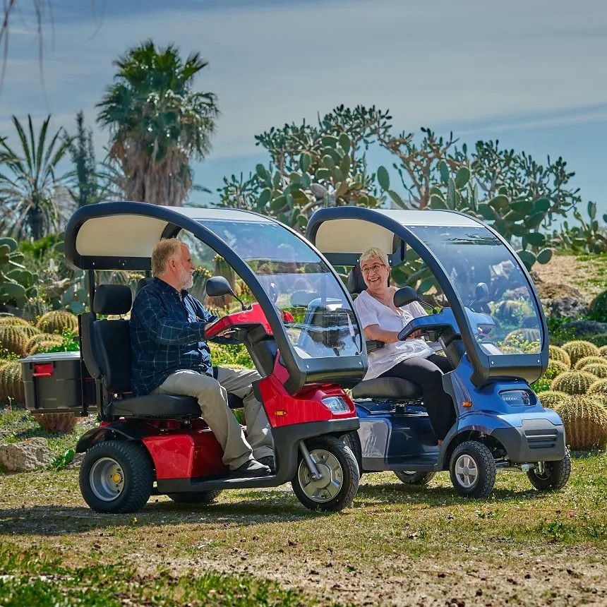 Afiscooter S / S3 - 3-Wheel Single Seat Scooter - Red Color W/ Canopy  - Riding Beside an S4 4-Wheel Single Seat Scooter W/ Canopy in Blue Color
