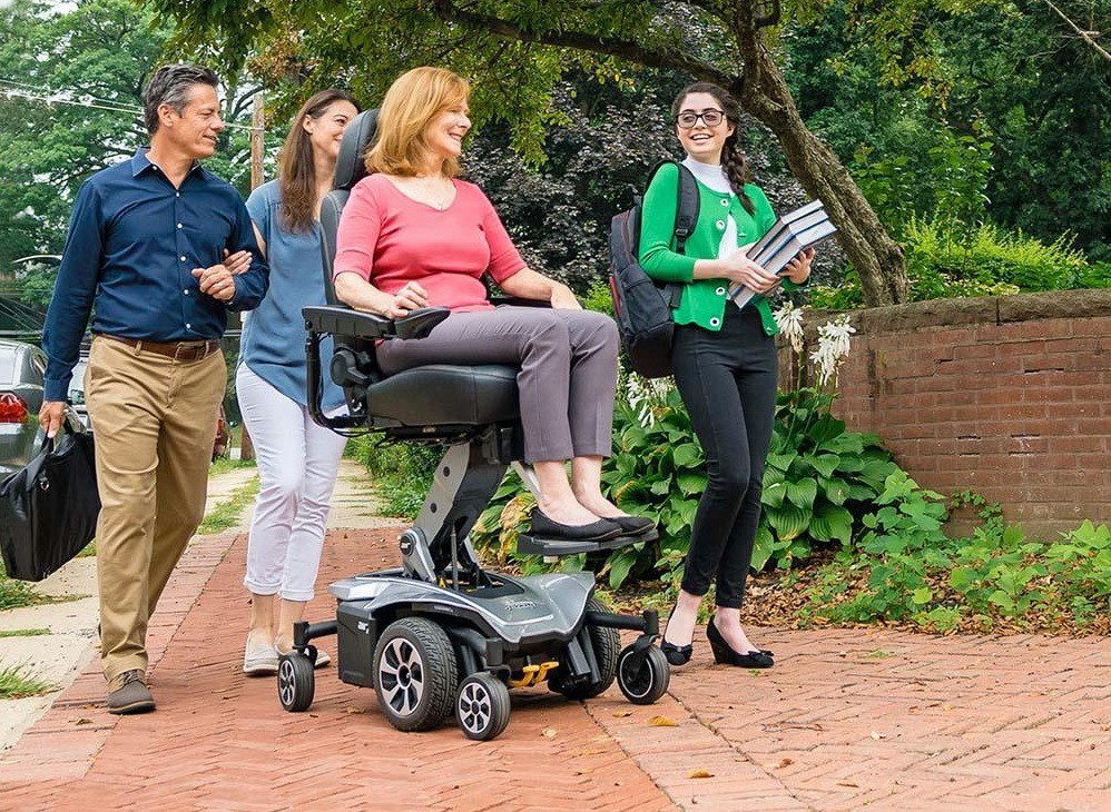 Woman Enjoying Ride on an Elevating Power Chair Wheelchair