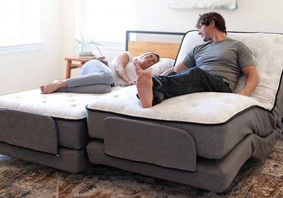 Man and woman resting on home adjustable premier care beds with massage. 