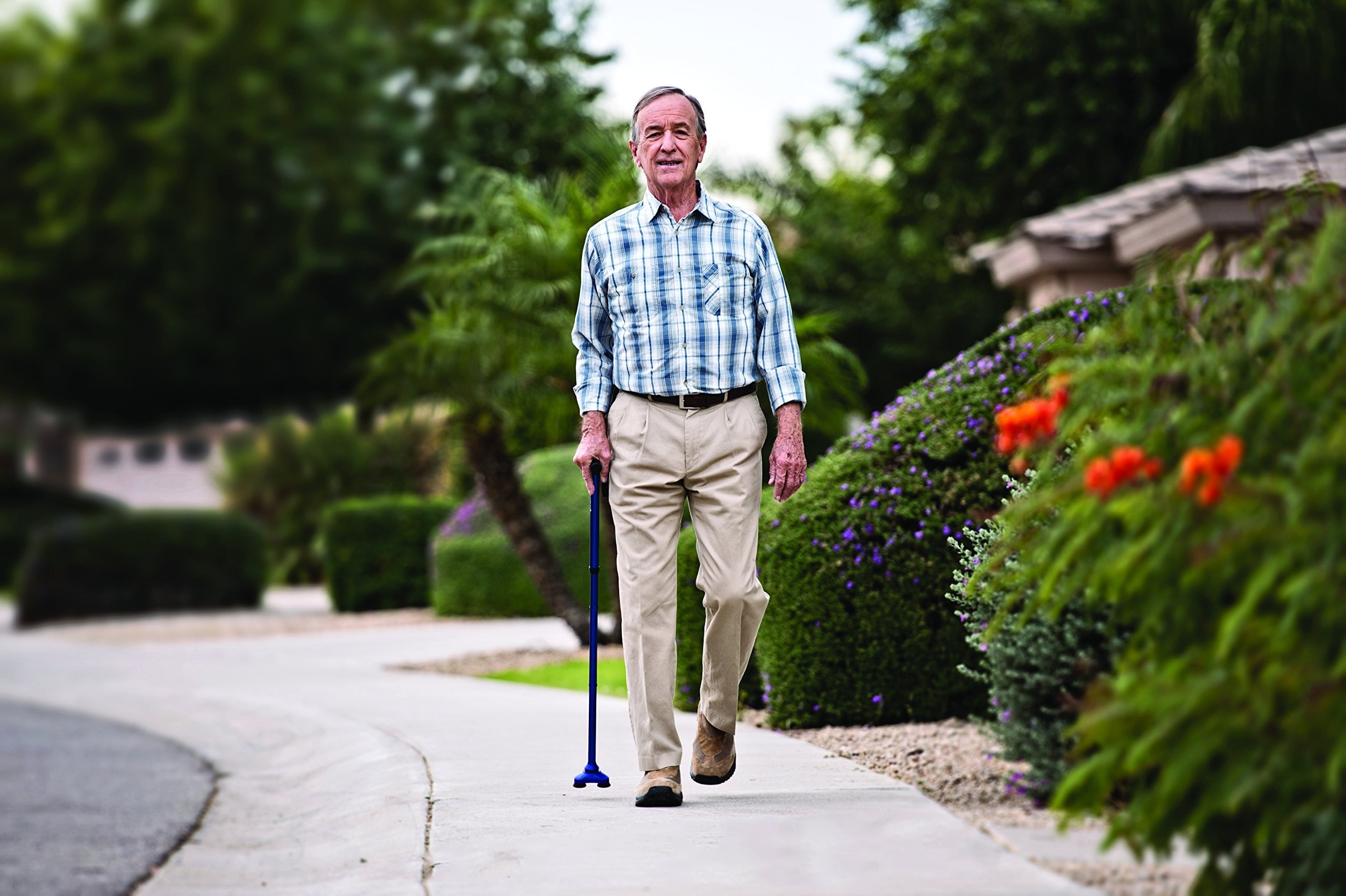 A man going for a walk using a walking cane. 